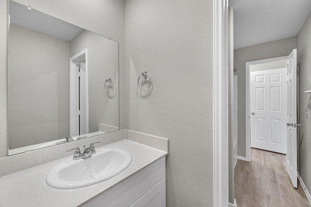 bathroom featuring hardwood / wood-style flooring and vanity