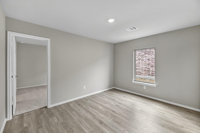 unfurnished room with light hardwood / wood-style floors