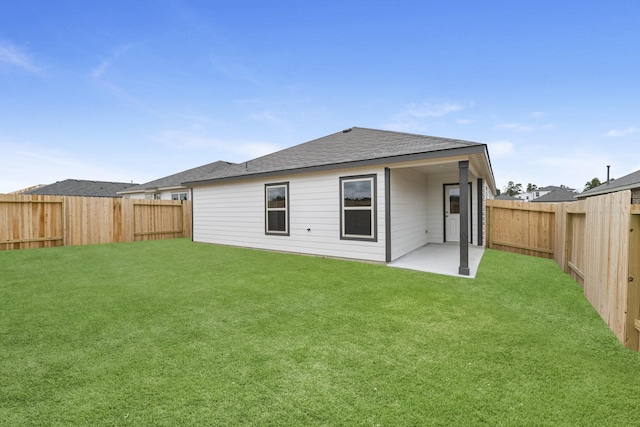 rear view of property featuring a lawn and a patio