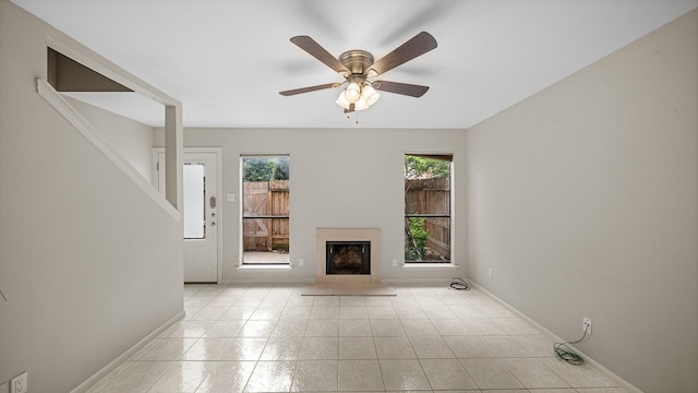 unfurnished living room featuring ceiling fan and light tile patterned floors