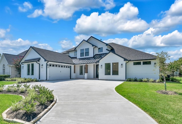 modern farmhouse style home featuring a front yard and a garage