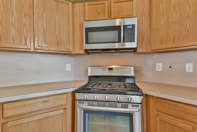 kitchen featuring appliances with stainless steel finishes and light brown cabinets