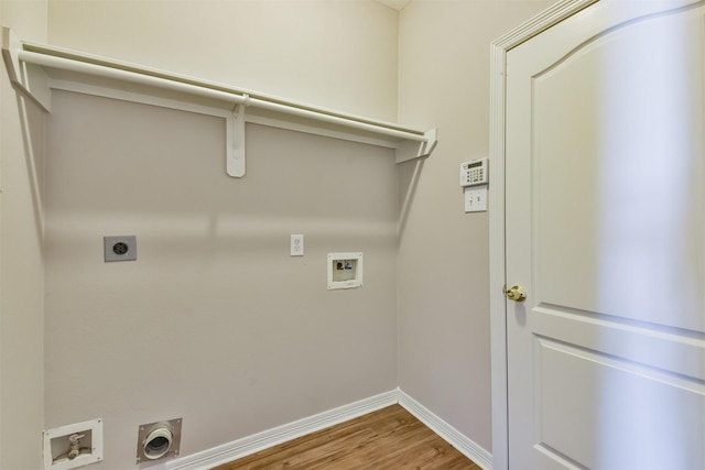 washroom featuring electric dryer hookup, hookup for a washing machine, and hardwood / wood-style floors