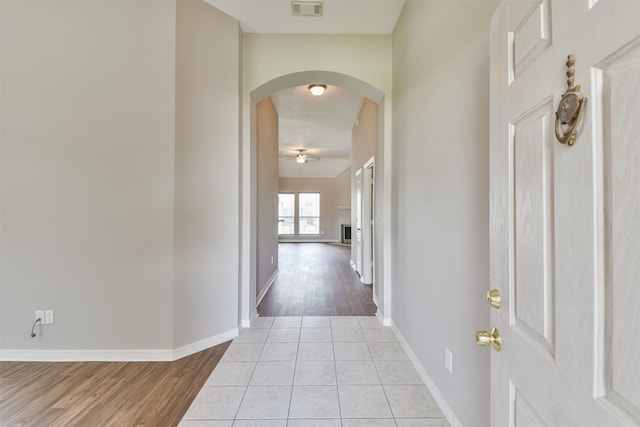 hall featuring light tile patterned floors