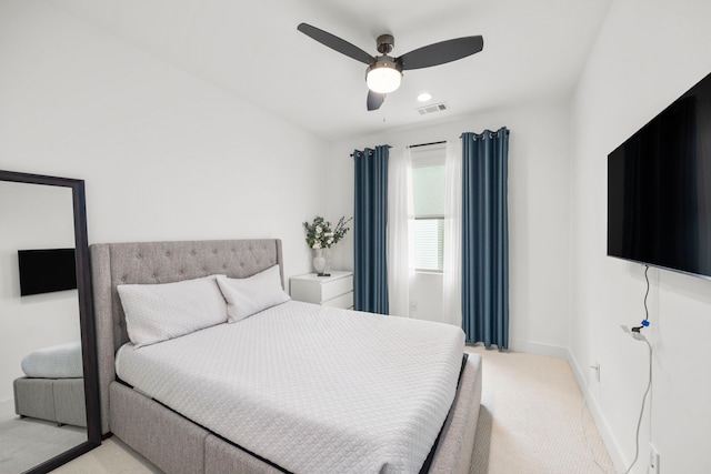 bedroom with ceiling fan and light carpet