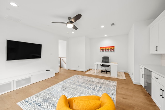 home office featuring ceiling fan and light hardwood / wood-style flooring