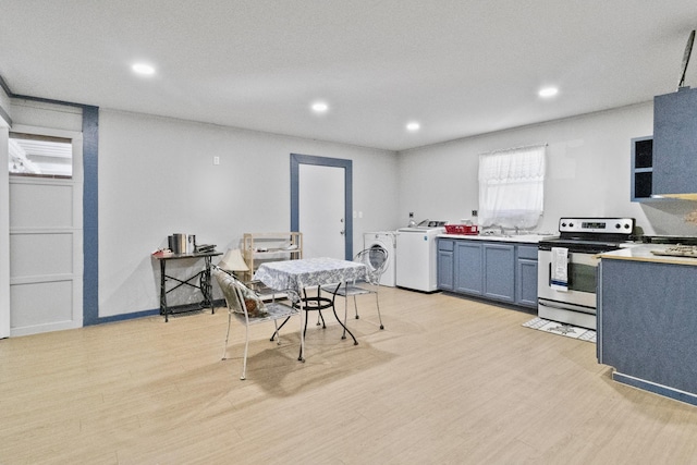 dining area featuring light hardwood / wood-style floors, separate washer and dryer, and sink