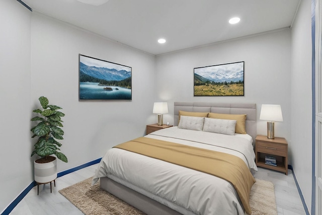 bedroom with ornamental molding and light hardwood / wood-style flooring