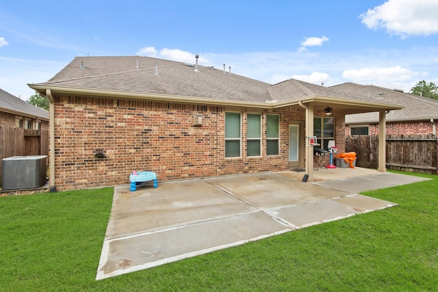 back of house featuring central air condition unit, a patio area, ceiling fan, and a yard