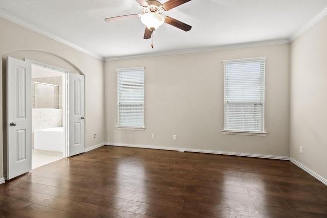 empty room featuring dark hardwood / wood-style flooring, ceiling fan, and crown molding