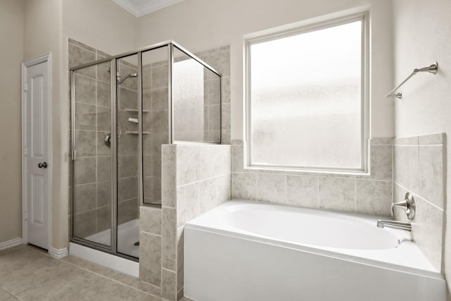 bathroom with tile patterned floors, crown molding, and separate shower and tub