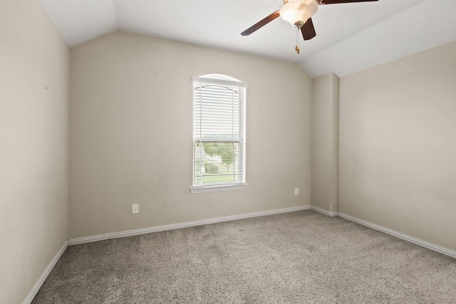 carpeted empty room featuring ceiling fan and lofted ceiling