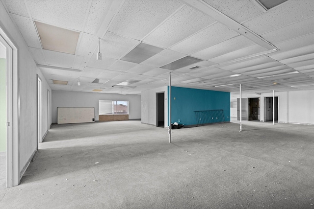 basement with a paneled ceiling