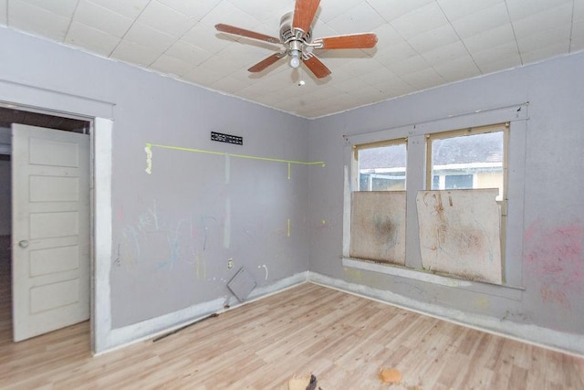 empty room with light wood-type flooring and ceiling fan