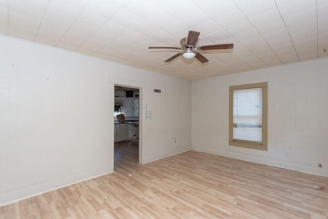 unfurnished room with ceiling fan and light hardwood / wood-style floors