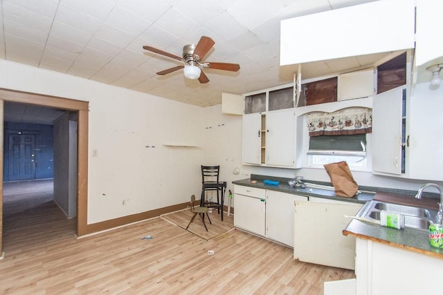 kitchen with ceiling fan, sink, white cabinets, and light hardwood / wood-style floors