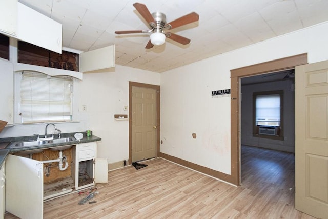 kitchen with white cabinetry, ceiling fan, sink, and light hardwood / wood-style floors