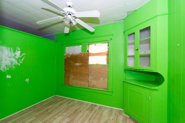 spare room with ceiling fan and light wood-type flooring