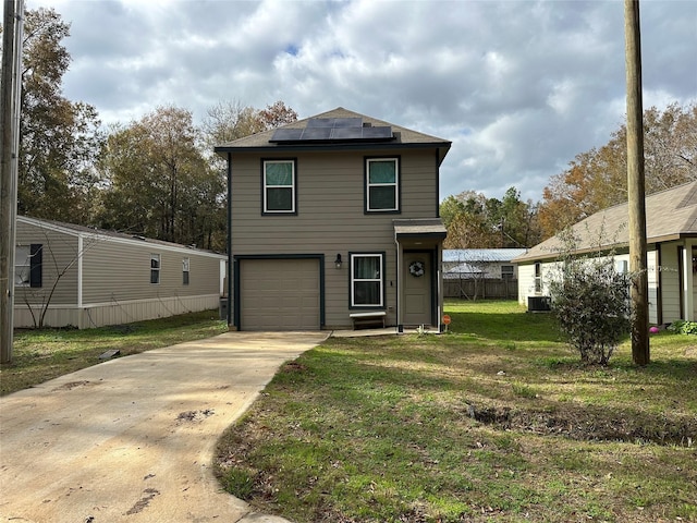 view of property featuring solar panels, central air condition unit, a front yard, and a garage