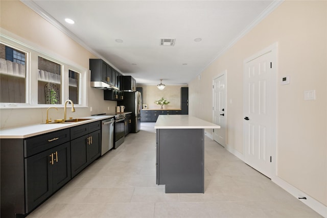 kitchen with ornamental molding, a center island, stainless steel appliances, and sink