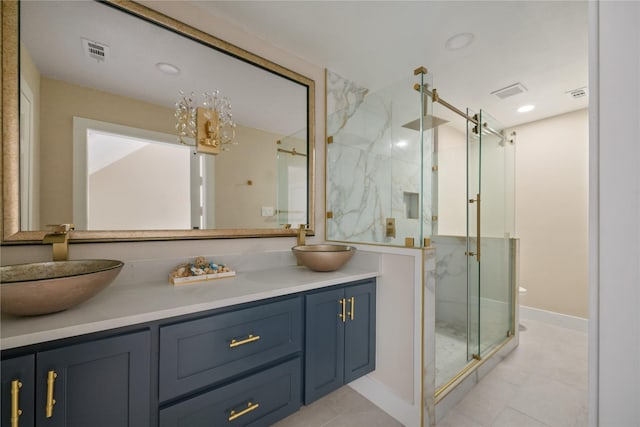 bathroom featuring tile patterned flooring, vanity, and a shower with shower door