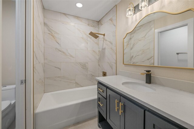 full bathroom featuring vanity, toilet, and tiled shower / bath