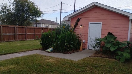 view of outbuilding with fence