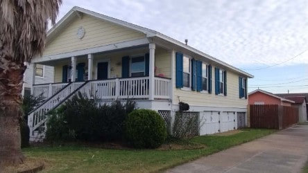 view of front of property featuring covered porch and stairway