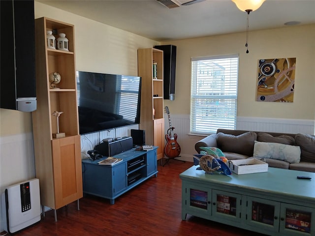 living room with wainscoting and dark wood finished floors