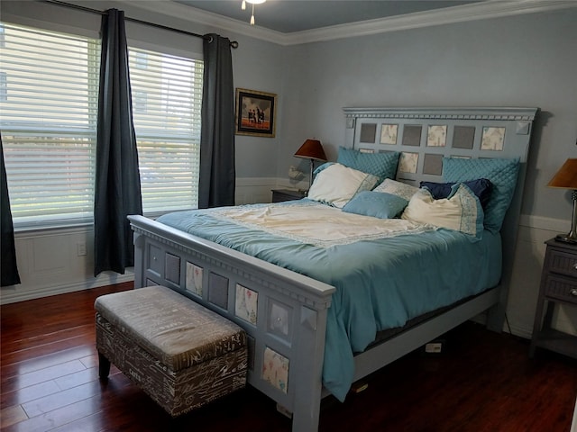 bedroom featuring wood finished floors and crown molding