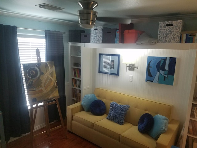 living area with wood finished floors and visible vents