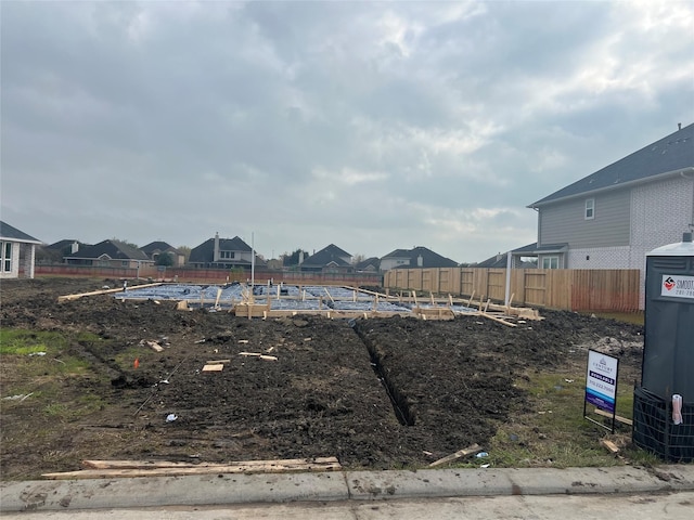 view of yard featuring fence and a residential view