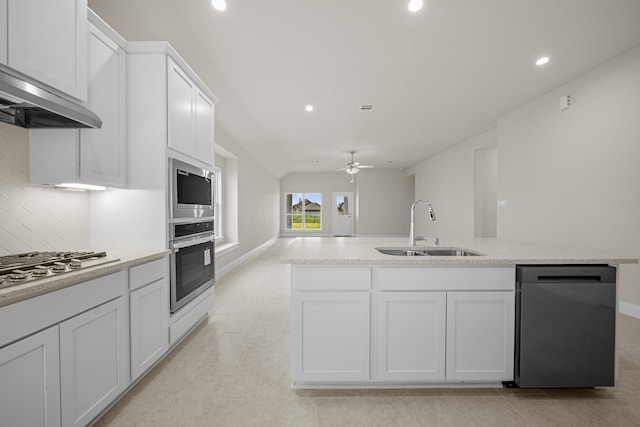 kitchen featuring white cabinetry, appliances with stainless steel finishes, ventilation hood, and a sink