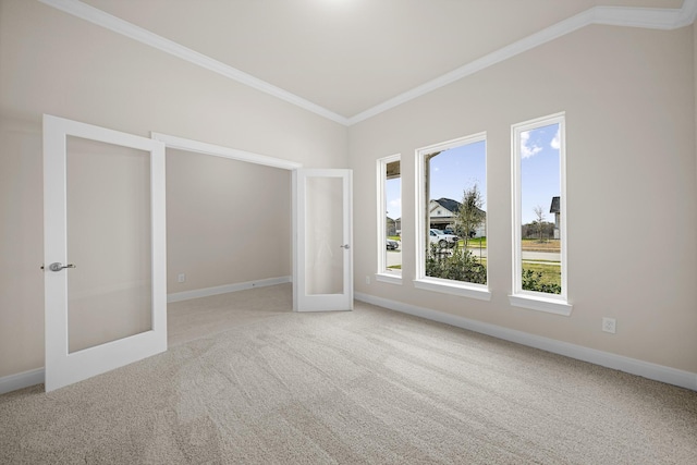 unfurnished bedroom with baseboards, ornamental molding, carpet flooring, and french doors