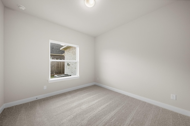 unfurnished room featuring baseboards and carpet flooring