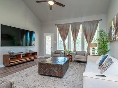 living room with wood-type flooring, ceiling fan, and lofted ceiling