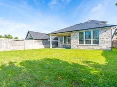 rear view of house with a yard