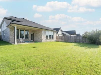 rear view of house featuring a lawn