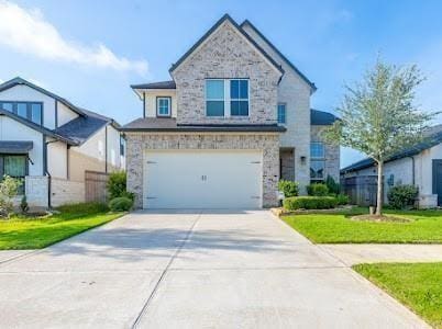 view of front of property featuring a front yard and a garage