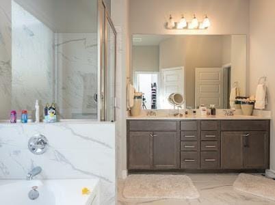 bathroom with vanity and separate shower and tub