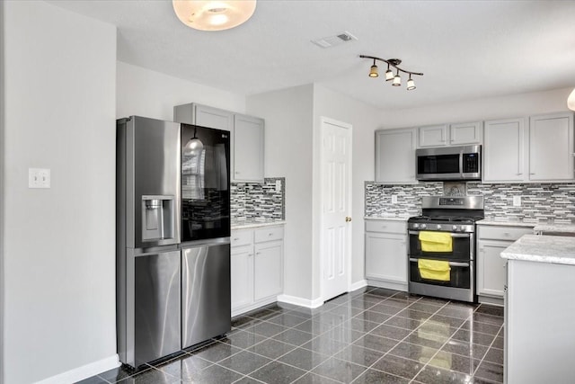 kitchen featuring decorative backsplash, sink, and appliances with stainless steel finishes