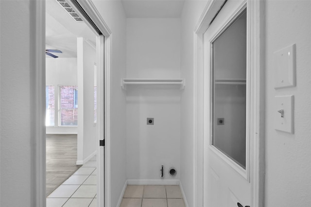 washroom with electric dryer hookup, ceiling fan, and light tile patterned floors