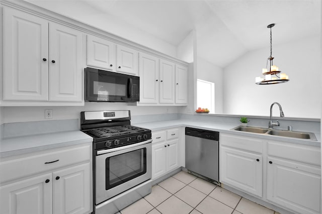 kitchen featuring lofted ceiling, white cabinets, sink, light tile patterned floors, and appliances with stainless steel finishes