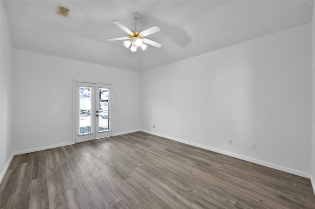 unfurnished room featuring ceiling fan, dark wood-type flooring, and french doors