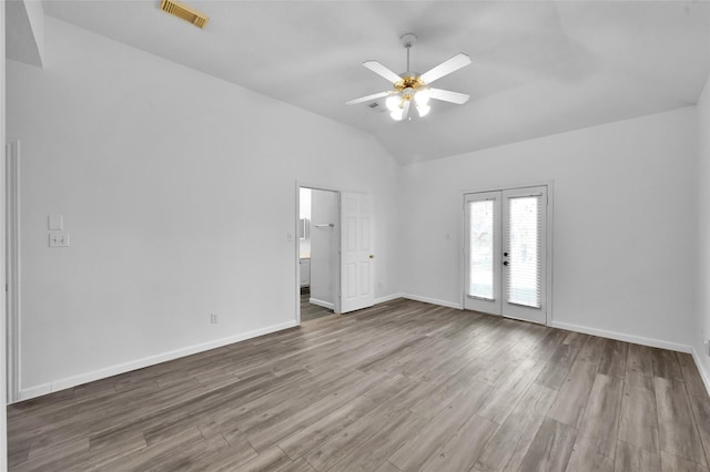 spare room featuring ceiling fan, french doors, lofted ceiling, and hardwood / wood-style flooring