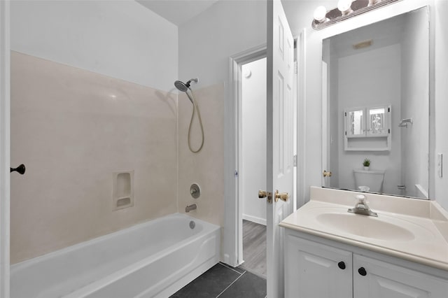 full bathroom featuring tile patterned flooring, vanity, toilet, and washtub / shower combination