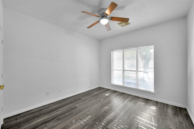 spare room featuring ceiling fan and dark wood-type flooring