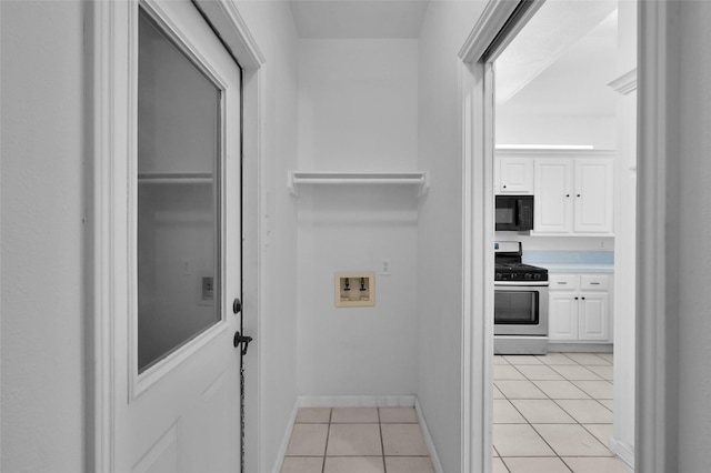 laundry room with light tile patterned flooring and washer hookup