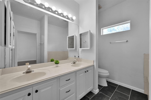 bathroom featuring tile patterned floors, vanity, and toilet