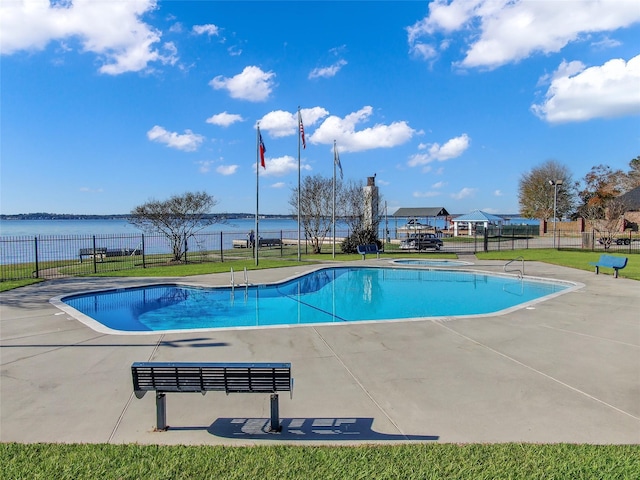 view of swimming pool with a patio area and a water view